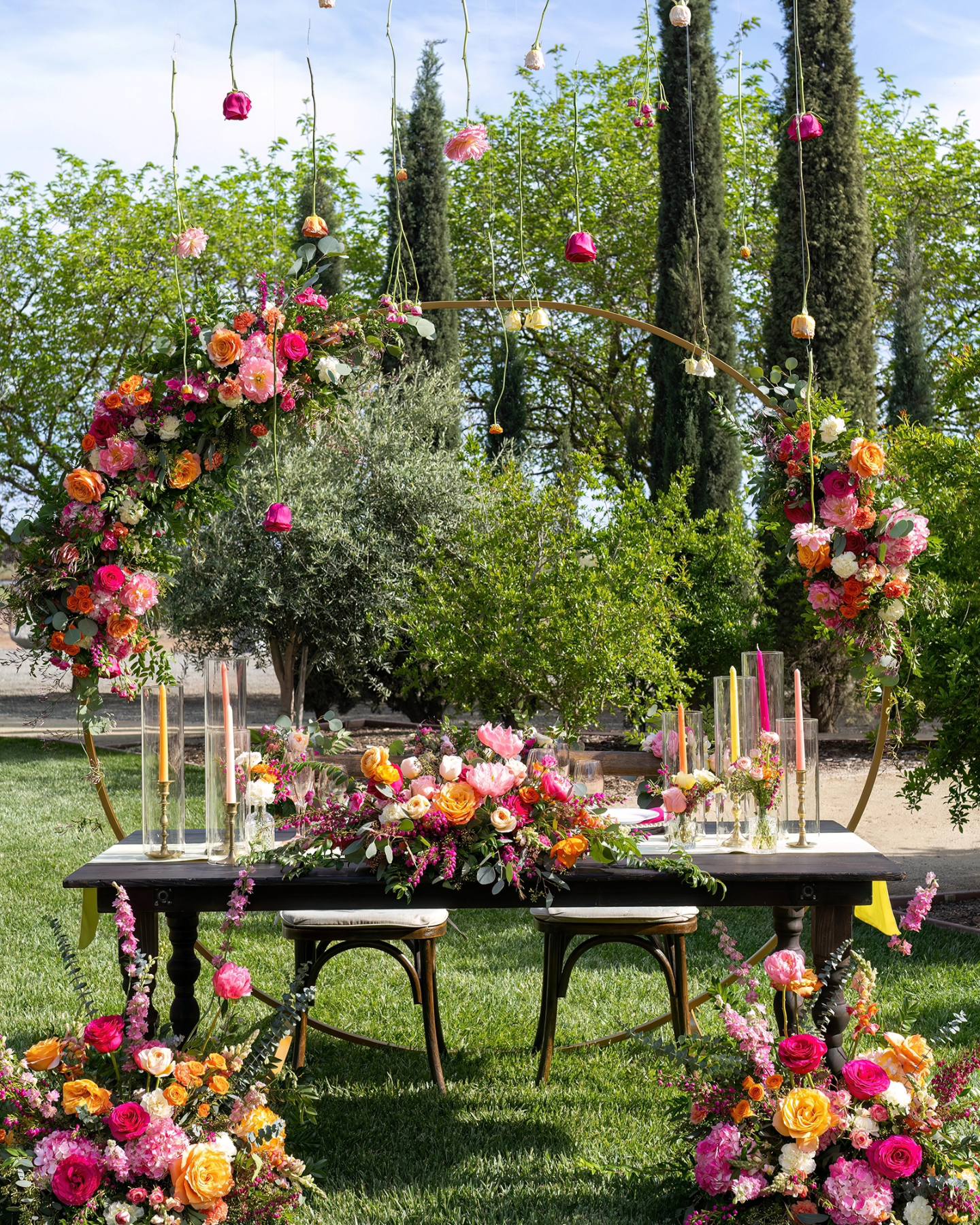 bright pink and orange summer wedding ceremony flowers